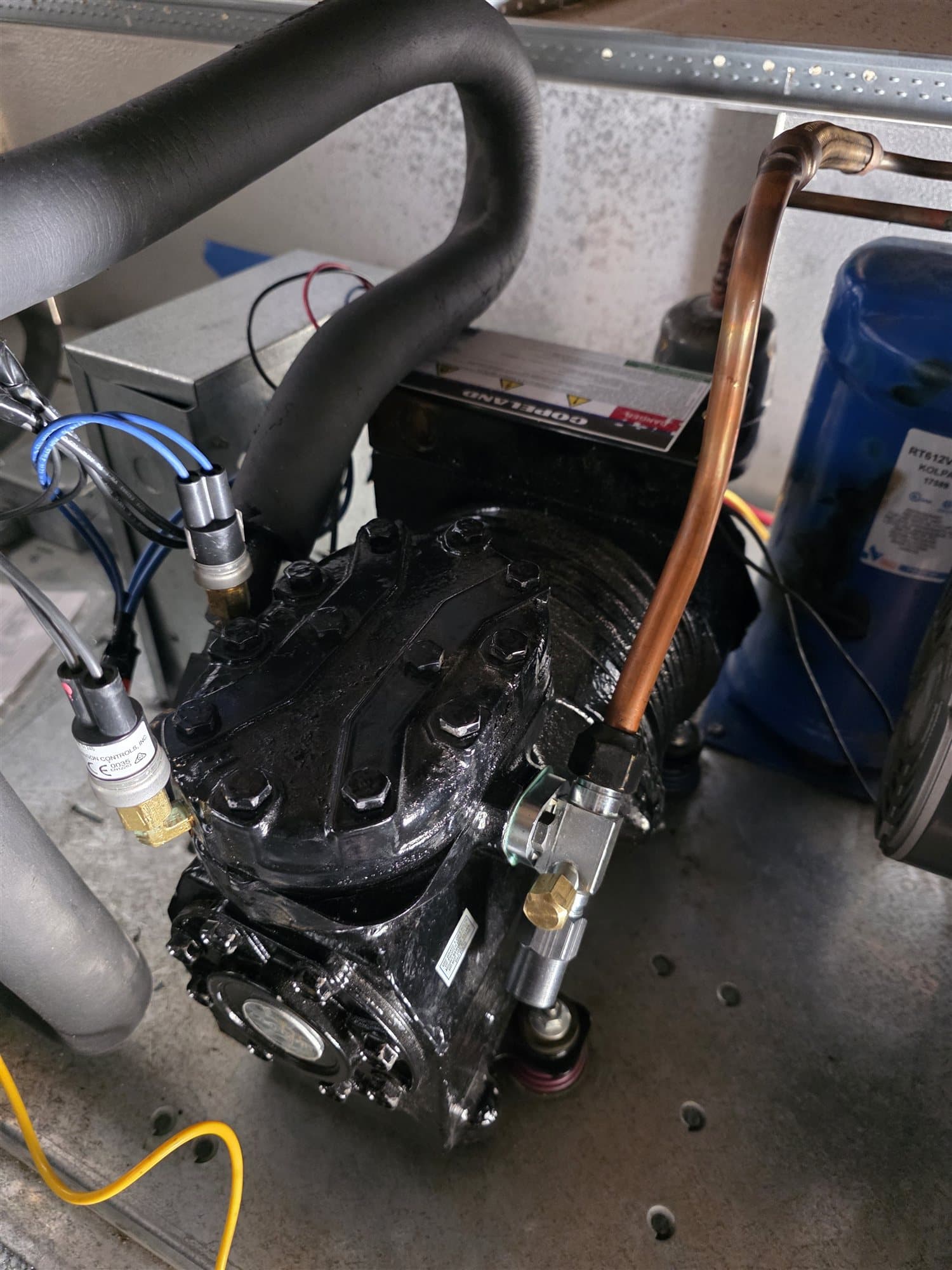 Commercial refrigeration compressor and copper piping during service