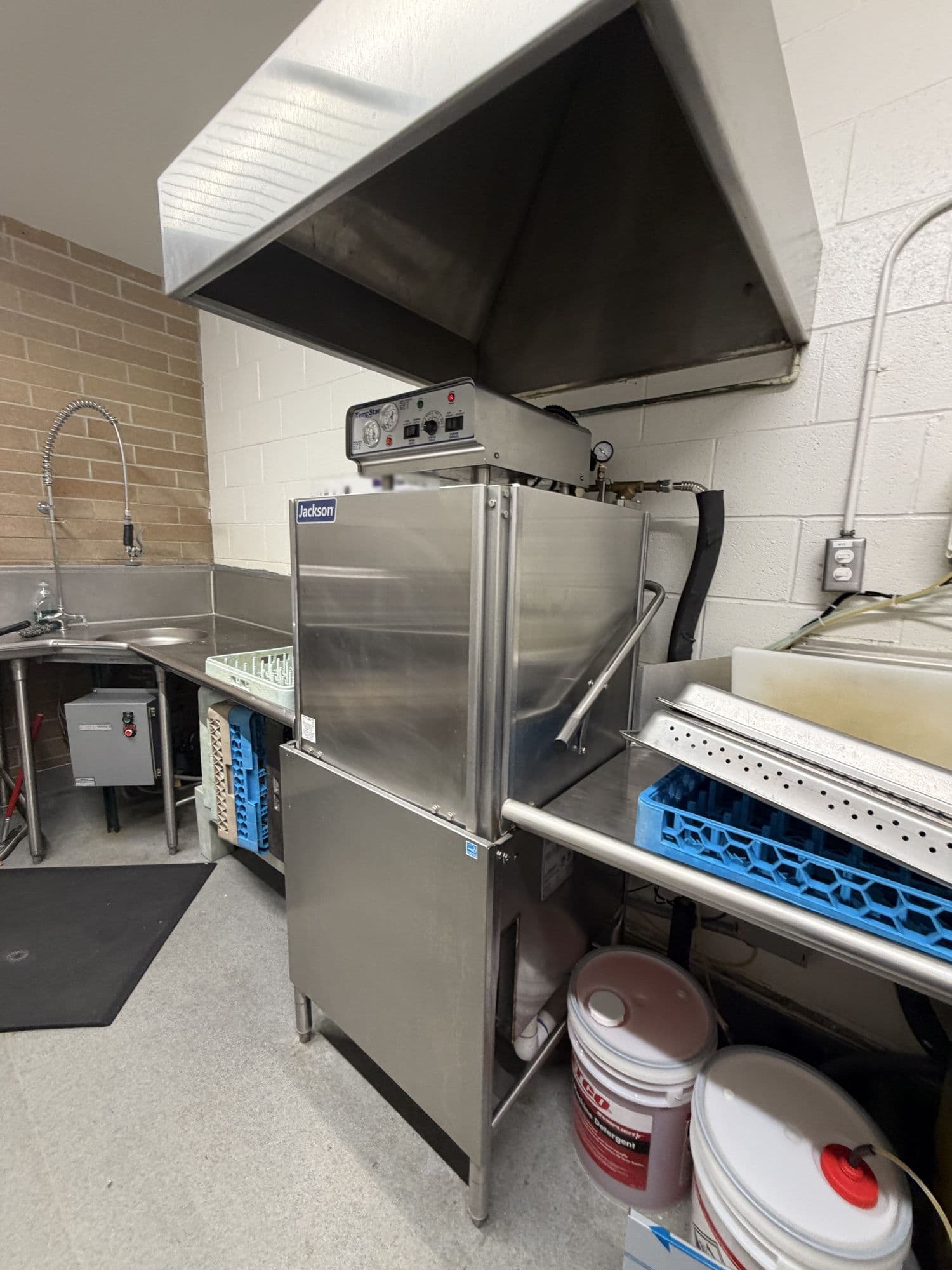 Commercial door-type dish machine in a restaurant dish room