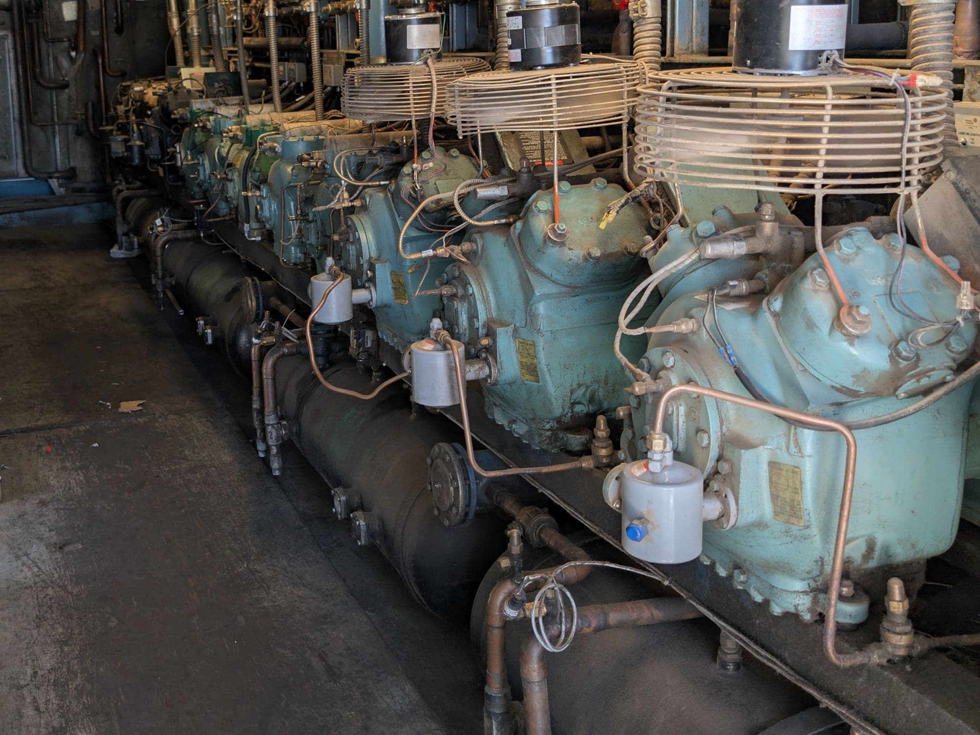 Row of commercial refrigeration compressors on a rack system