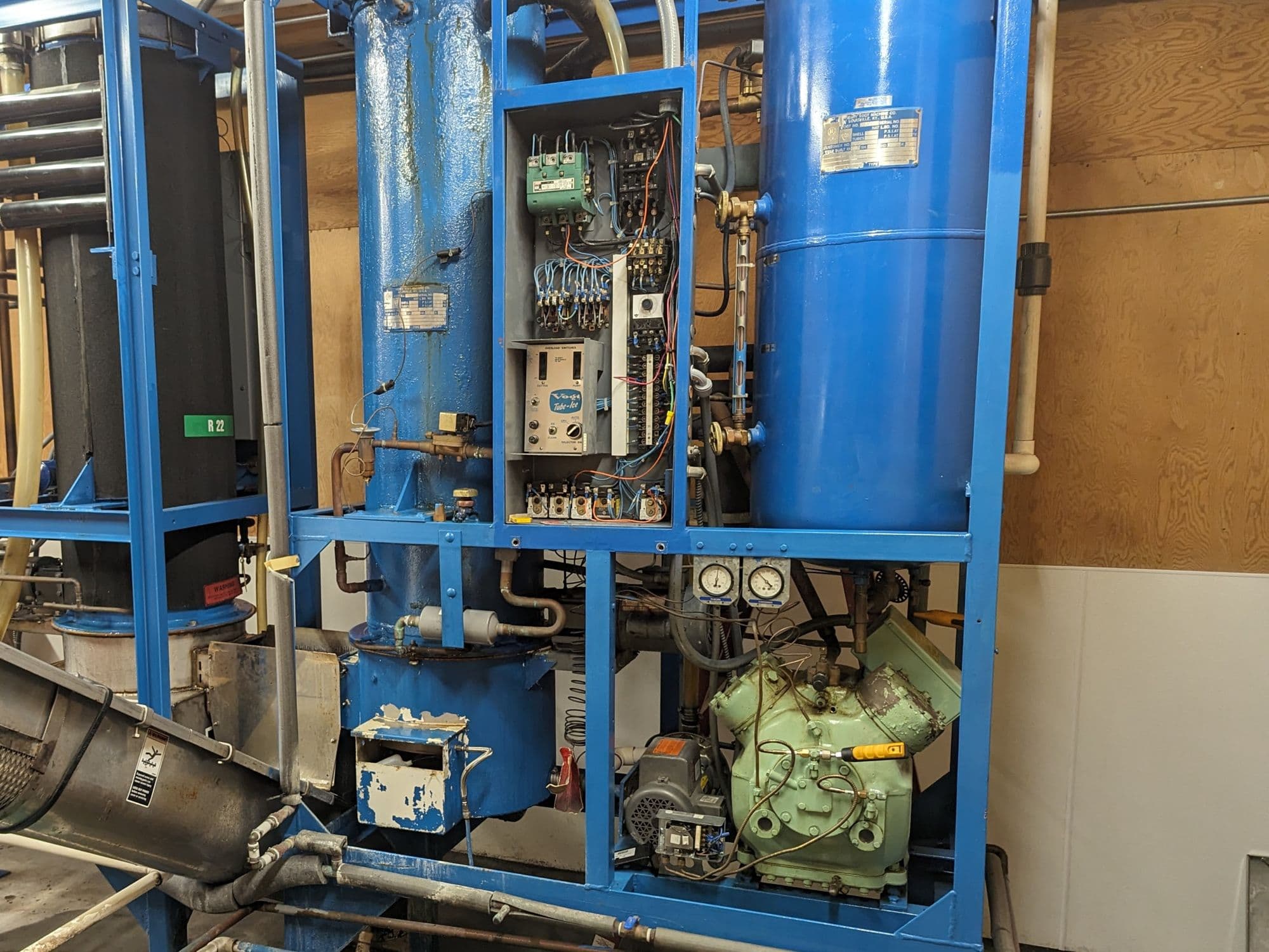 Industrial ice machine with its control panel open for service